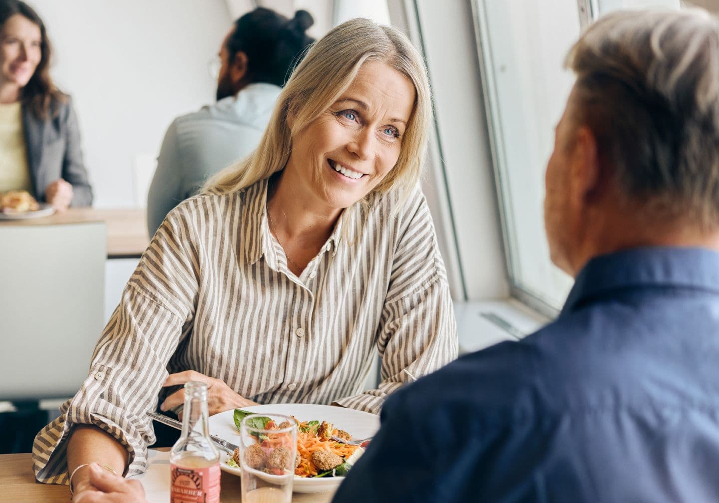 Woman talking with her husband over dinner on the ferry